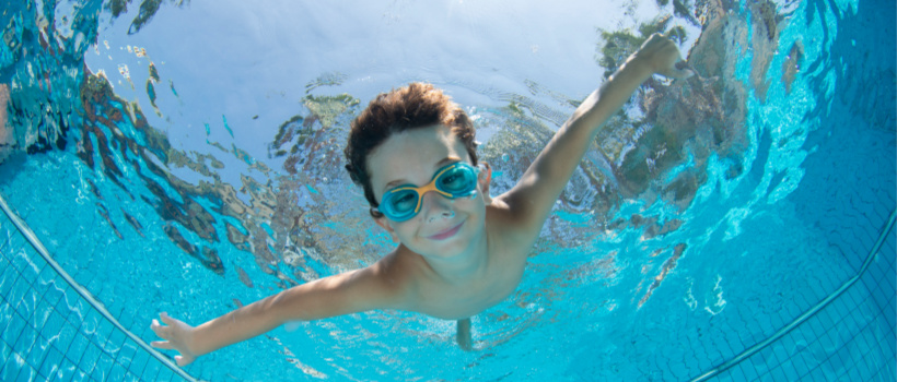 BOY SWIMMING IN THE POOL